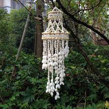 To get the look, decorate a string of small white lights with clean, dry shells. Capiz Seashell Wind Chime Feelara Handmade Natural Conch Shells Outdoor Indoor Beautiful Wind Chime For Garden Yark Patio And Home Decor D Style Buy Online In Saint Vincent And The Grenadines At