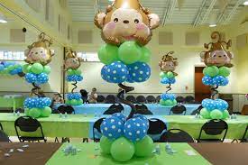 Jungle theme safari baby shower decorations with green balloon garland arch backdrop, tropical leaves decoration, ivy vines, banner sign, neutral birthday party supplies for boy or girl. Baby Shower Decorations And Themes Parenting