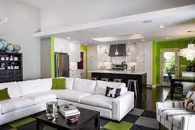 Large crème colored tiles cover the entire space whereas the kitchen cabinets are a soft chestnut shade. Open Kitchen And Living Room Design Ideas