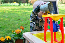 Outside Water Play At How We Montessori 17 Months Water Wheel And Sand Table Montessori Toddler Sand Table Montessori