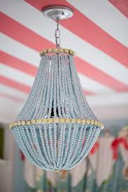 Upcycle A Plain Chandelier Into A Beaded Showpiece Wood Bead Chandelier Diy Chandelier Beaded Chandelier