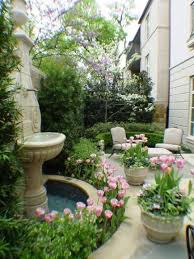 Small Garden Seating Area With A Small Fountain Surrounded By Flowers Garden Fountains Courtyard Garden Beautiful Gardens