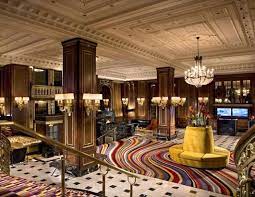The Blackstone Hotel In Chicago Features Swirling Rainbow Colored Carpet And Gold Couches Amid Original Iron Beautiful Hotels Lobby Chicago Hotels Home N Decor