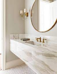 Subtle color scheme works best to complement the elements. White And Gold Bathroom With Marble Floating Vanity Contemporary Bathroom Bathroom Vanity Style Modern Luxury Bathroom Bathroom Design Luxury