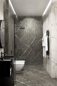 Stock footage modern minimalist bathroom interior with simple glass walk in shower, mirror, and white wash basin on wall decorated with glossy black marble tile and gray ceramic floor. Timeless Fabulous Marble Tile Textured Shower Room Black Marble Bathroom Marble Bathroom Designs Grey Marble Bathroom