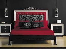 Top view of multicultural women putting makeup and doing hairstyle at metal decor next to bed in dark unicolor bedroom interior with mockup of poster. Bedroom Designs Black Red Bedroom Designs