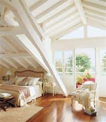 Contemporary Cottage Attic Bedroom With Sloped White Beamed Ceiling Honey Wood Floors And Balcony Dream House Home House Design