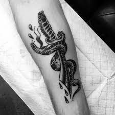 The skull and snake tattoo have a lot of meaning for those that wear it but let us investigate what each image represents on their own. 50 Snake Dagger Tattoo Ideas For Men Sharp Serpent Designs