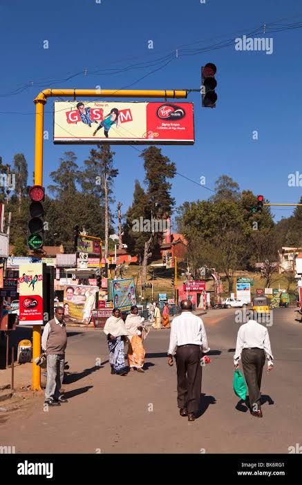 India, Tamil Nadu, Udhagamandalam (Ooty), Charing Cross people walking below traffic lights and virgin media advertisement Stock Photo - Alamy