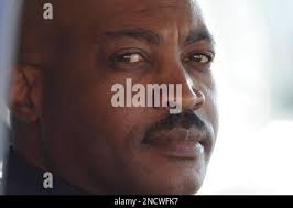 Fort Hood police officer Mark Todd, left, is presented with a signed  football by Baylor athletic director Ian McCaw, right, during an NCAA  college football game between Texas and Baylor, Saturday, Nov.