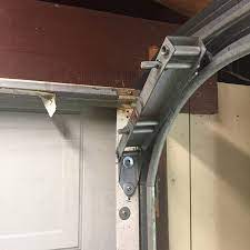 What can be done if there is less than 4 ¾ inches (121 mm) of clearance space over the door? Garage Door Low Head Room Quick Closing Bracket