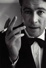 Year: 1960's Peter Beard writing in his journal while his legs are in the  Mouth of a crocodile, Kenya.