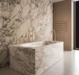 Arabescato marble and gold accents come together in this ...