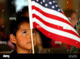Evander Gilbert, 5, waves a flag during a yellow ribbon ceremony, Tuesday,  Aug. 30, 2005, in Farmington, N.M., held to honor 15 National Guard  soldiers that are among approximately 120 members of