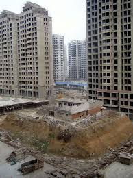 We Shall Not Be Moved Chinese Couple S Home Left On Dust Island For Four Years After Skyscraper Developers Move In Around Them Skyscraper Building Small Buildings