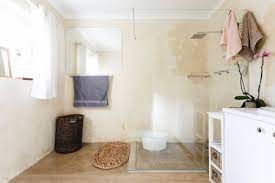 White subway tile shower/tub surround with black and white patterned tile flooring in cute bathroom. 19 Beautiful Showers Without Doors