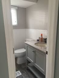 Updated Bathroom Wood Like Tiles Gray Vanity White Wainscoting Panels With Light Gray Walls Gray Vanity Bathroom Vanity Remodel Guest Bathroom Small