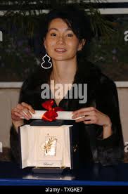 Maggie cheung with her award for best actress hi-res stock photography and  images