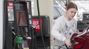 Michigan residents upset with soaring prices at the pump protest at gas station