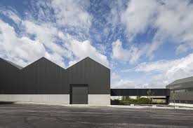 Zwei interior design and architecture merged two abandoned warehouses into one industrial chic coffee shop in melbourne, australia! Ademia Office Building And Industrial Warehouse Joao Mendes Ribeiro Archdaily