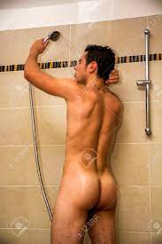 Naked Athletic Young Man Taking Shower At The Bathroom To Refresh While  Holding The Shower Head. Stock Photo, Picture and Royalty Free Image. Image  41513238.