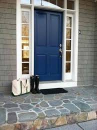 Shutters painted deep navy blue match the front door and frame the windows without stealing the show. 27 Chic Dark Front Doors To Try For Your Entry Shelterness