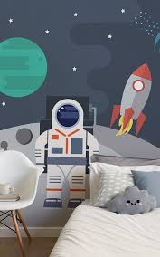 With cute wicker baskets or patterned totes, you can get both fun designs and playroom storage. Retro Astronaut Wallpaper Cartoon Astronaut Design Muralswallpaper Space Themed Bedroom Kids Bedroom Inspiration Space Themed Room