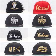 A Few Snapbacks From Our Collection Barber Clothing Barber Shop Barbershop Design