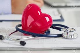 Read Heart And Stethoscope Laying On Cardiogram Chart At Doctors