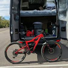 Red Ibis Hd4 Mountain Bike Leaning Against Mercedes Benz Sprinter Van Vtt