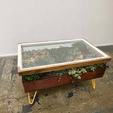 Stunning Coffee Table With Indoor Garden For A Healthier Interior Constructed of solid acacia wood with an antiqued mocha stain and metal legs, this table is built to be both durable and stylish.