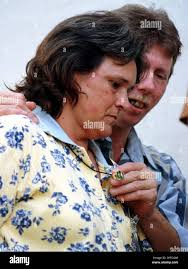 Mike Long, stepfather of Lydia Dew, one of the two Pearl High School  students killed during a shooting rampage at the Pearl, Miss., school Oct.  1, 1997, caresses his late stepdaughter's class