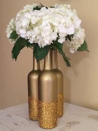 For one thing, if you use the bottles as vases, their height makes it tricky to achieve a balanced look with a full bouquet. Glitter And Metallic Gold Dipped Wine Bottle Diy Wedding Centerpieces Oh Best Day Ever