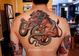 Lion tattoos combine well with tribal art because of the manes that are easy to stylize with tribal patterns. Lion Tattoo Back Lion Tattoo Tattoos Snake Tattoo