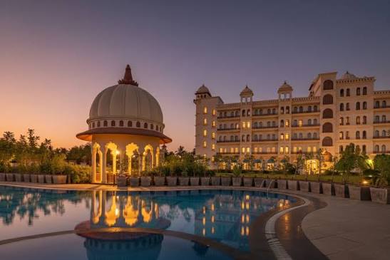 Ease into the evening glow &mdash; calm waters, warm lights, and peaceful vibes  by the pool. Experience tranquil evenings at Uday Palace Navsari, A member  of Radisson Individuals. Book Now: +91 63589