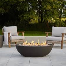 The fire pit converts into an outdoor table when not in use using a wooden topper. Real Flame Riverside 48 In X 15 In Oval Concrete Composite Propane Fire Pit In Shale 590lp Shl The Home Depot