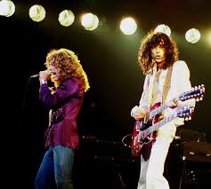 File:Jimmy Page with Robert Plant 2 - Led Zeppelin - 1977.jpg - Wikimedia  Commons
