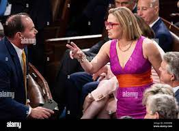Sen. Kyrsten Sinema (I-Ariz.) speaks with Sen. Mike Lee (R-Utah) during a  joint session of Congress in the House chamber at the U.S. Capitol July 19,  2023. (Francis Chung/POLITICO via AP Images