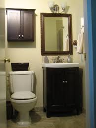 Black Bathroom Storage Cabinet Over Toilet Small Dark Brown Wooden Cabinet With Double Doors Also White Toilet Under It Combined Small Bathroom Vanities Bathroom Shelf Decor Bathroom Storage Over Toilet