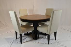 Sturdy, black wood legs support the chairs and contrast with all of the available upholstery. Round Dining Table W Parson Chairs Pierce Furniture