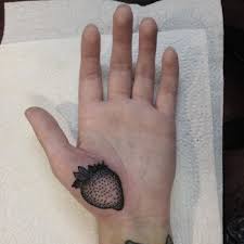 A tattoo gun can puncture the skin between 50 and 3,000 times per minute, penetrating the skin about one millimeter deep in the skin to the dermis. Black Strawberry Tattoo On The Palm Tattoogrid Net