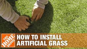 Laying out the artificial grass. How To Install Artificial Grass The Home Depot Youtube