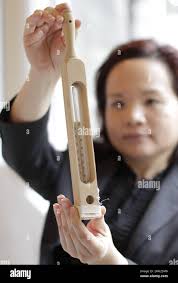 A nursing school alumni displays a thermometer used in early 19th century  during the nursing school celebration event at University of British  Columbia in Richmond, Canada, Feb. 10, 2015. In honour of