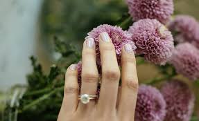 Both of the accent nails feature a thin silver stripe with a crystal in the center. Spring Wedding Nails