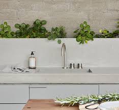 We believe in helping you find the product that is right for you. A Row Of Plants Along The Backsplash Adds A Green Touch To This Kitchen
