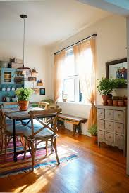 Eclectic Dining Room With Colorful Accents Plants Bistro Chairs Hardwood Floor Blue Cabinet Wi Farmhouse Dining Room Set Farmhouse Dining Rooms Decor Home