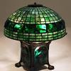 Tiffany studios jeweled turtleback desk lamp, circa 1900 a tiffany studios bronze table lamp base decorated with jeweled green favrile swirl glass balls supporting the turtleback sha. 1