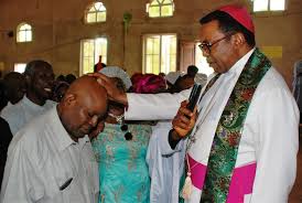 Christian chukwu being helped to walk down from staircase. Arch Bishop Enugu Eclisiasticle Emmanuel Chukwuma Oon Blessing Coach Christian Chukwu Mfr And His Wife At
