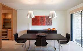 The dining table and chairs are simple wooden affairs and a candelabra with white tapers is hanging from the ceiling. 15 Modern Minimalist Dining Room Designs Home Design Lover