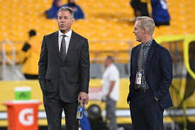 Oct 28, 2024; Pittsburgh, Pennsylvania, USA; Hall of Fame quterback Troy Aikman stands with his Monday Night Football Broadcast announcer Joe Buck before a game between the Pittsburgh Steelers and New York Giants at Acrisure Stadium. Mandatory Cre